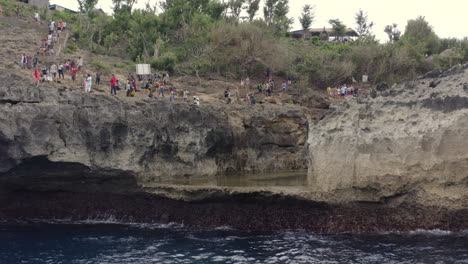 A-trench-with-still-water-inside-of-the-coast-of-Broken-Beach-with-tourists-taking-pictures-on-its-sides,-Nusa-Penida,-Bali,-Indonesia