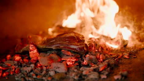 Close-up-view-of-preparing-delicious-steak-on-a-firewood-burning