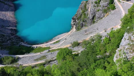 Medium-wide-angle-aerial-drone-shot-of-Blue-Lake-and-surrounding-landscapes-in-Imotski-during-the-day