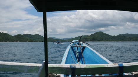 POV-Driving-shot,-inside-a-blue-pump-boat-anchor-in-front,-scenic-view-of-Sekotong-islands-in-Indonesia