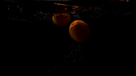 Orange-Dump-Into-The-Water-And-Slowly-Rising---Close-Up-Shot