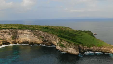 Aerial-view,-circling-around-the-Tanjung-Ringgit-cliff-in-Indonesia