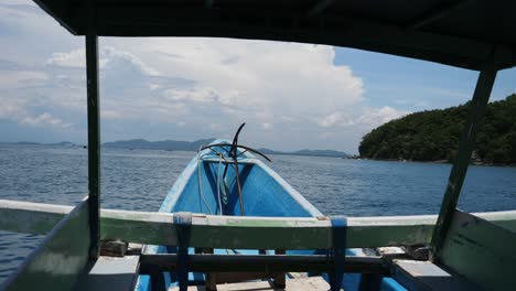 Looking-forward,-inside-a-pump-boat-anchor-in-front,-scenic-view-of-Sekotong-islands-in-Indonesia