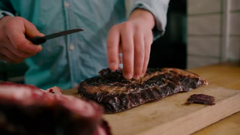 Chef-slicing-top-layer-of-the-steak-with-Steel-knife
