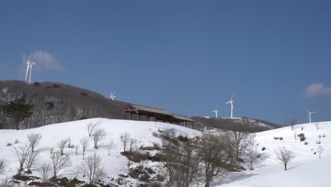 Wind-power-farm-in-the-snow-covered-mountain,-South-Korea