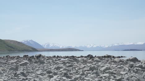 panning-view-of-lake-tekapo-from-right-to-left-the-rocks-on-the-beach