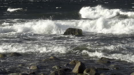 Waves-hitting-WWII-memorial-rock-in-sea