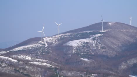 Wind-power-plants-are-seen-on-the-top-of-the-mountain,-South-Korea