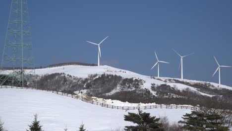 Wind-power-plants-are-seen-in-the-snow-covered-fields-valley-ranch,-Norway