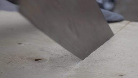 A-Worker-With-Gloved-Cutting-The-Wood-With-Marked-Line---Close-up-shot