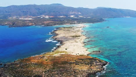 Aerial-view-of-peninsula-and-blue-water,-Elafonissi-Beach,-Crete,-Greece