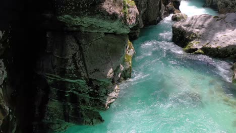 Aerial:-Vibrant-emerald-green-river-flowing-in-Great-Soca-Gorge-in-Slovenian-Triglav-National-Park