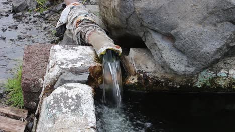 Water-flowing-out-of-concrete-drain-pipe