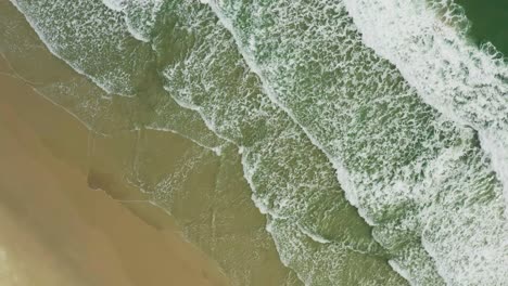 Aerial-top-view-of-waves-break-on-tropical-sand-beach