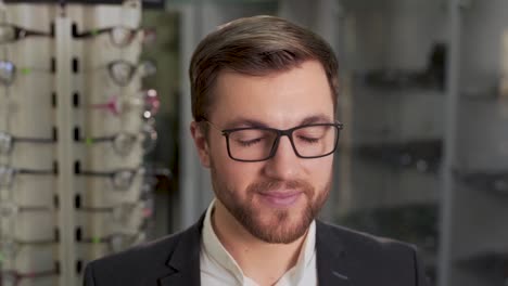 man-trying-on-glasses-in-store