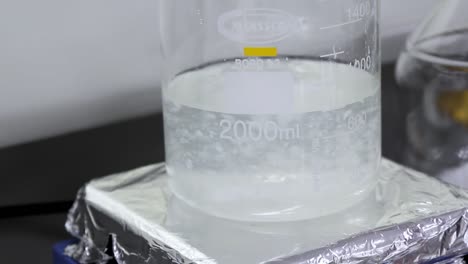 A-Beaker-Fill-with-Water-with-a-number-of-2000mL-and-has-a-Chemical-Composition-Mixed--Close-up-Shot