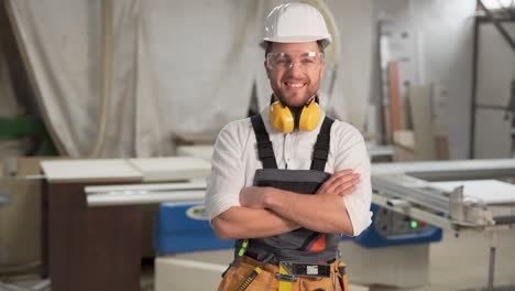 working-man-in-overalls-looks-into-the-camera-and-smiles