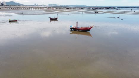 AERIAL-DOLLY-BACK,-Boats-High-And-Dry-At-Bang-Sean-Beach,-Chonburi