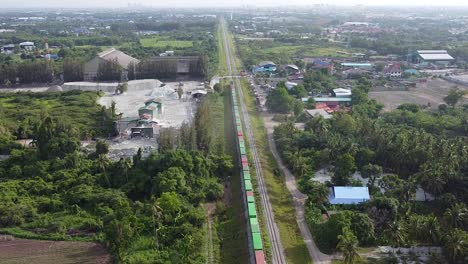 AERIAL-Long-Freight-Train-Traveling-Past-Old-Thailand-Mine