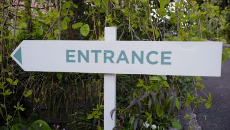 closeup-of-entrance-road-sign-and-green-plants-behind