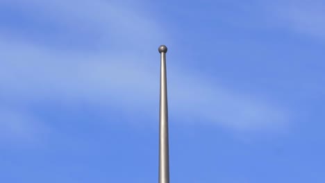 tip-of-the-pole-of-flag-in-a-sunny-day-mast