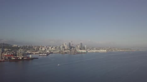 droneshot-flying-towards-Auckland-CBD-on-a-sunny-morning-with-ships-and-yacht-relaxing