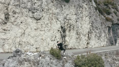 Man-operating-professional-camera,-making-video-on-limestone-rocks