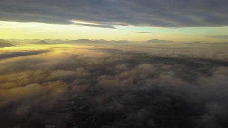 Flying-Above-Clouds-In-The-Sky-On-A-Golden-Hour-Sunrise