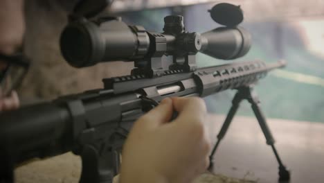 Shooter-reloading-sniper-rifle-at-shooting-range,-close-up-on-weapon