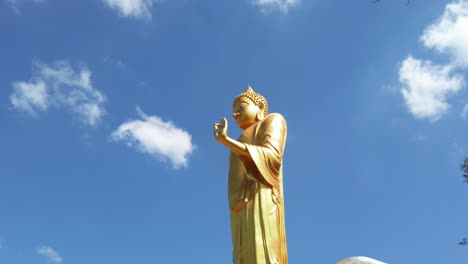 Huge-golden-Buddha-statue-in-Chiang-Khan-Skywalk,-Thailand--tilt-down