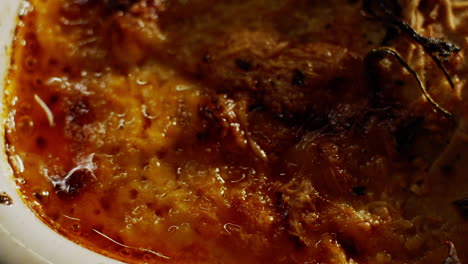 Bubbling-hot-crust-of-melted-cheese-in-lasagna,-italian-cuisine-background