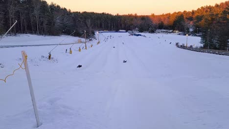 People-having-fun-doing-winter-tubing-downhill-in-Nashoba-tubing-park,-Massachusetts