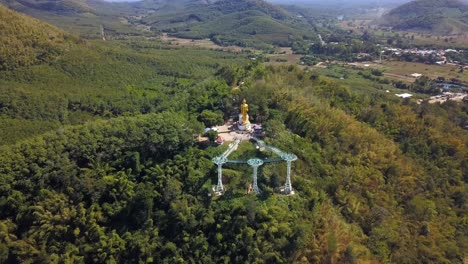 Aerial-shot-of-Buddha-statue-at-Chiang-Khan-skywalk-tourism-attraction-in-Loei-Thailand