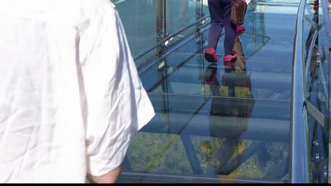 People-Walking-Through-The-Breathtaking-Glass-Skywalk-With-View-Of-Mekong-River-In-Chiang-Khan-District,-Loei,-Thailand---static-shot