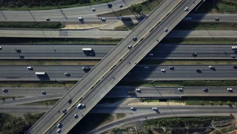 Static-aerial-drone-shot-of-busy-highway-interchange-ramps-with-city-traffic-vehicles