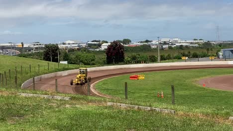 tractor-working-on-a-racing-runway-on-a-sunny-day