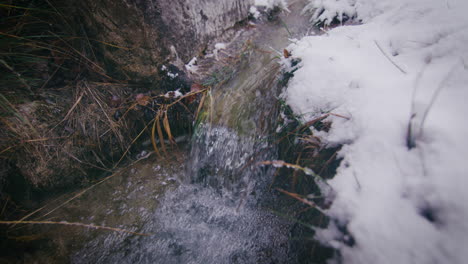 Crystal-clear-water-of-stream-rapid-in-pure-snowy-winter-scenery