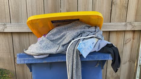 closeup-of-abandoned-clothes-in-the-trash-bin