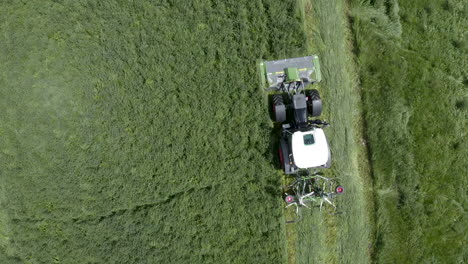 Tractor-with-mower-cutting-grass,-agricultural-machine-at-work-aerial-view