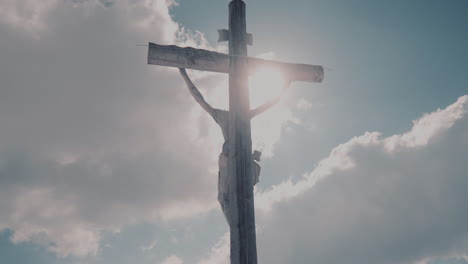 Wooden-Holy-Cross-illuminated-by-sun-on-sky-background,-Jesus-Christ-crucified