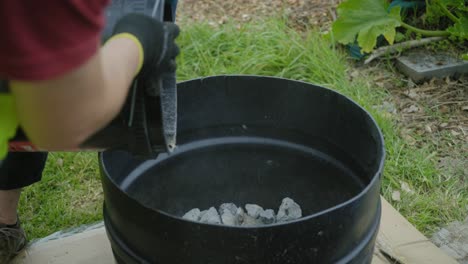 pouring-out-stones-vermiculite-rocks-out-of-the-bucket-to-a-big-container