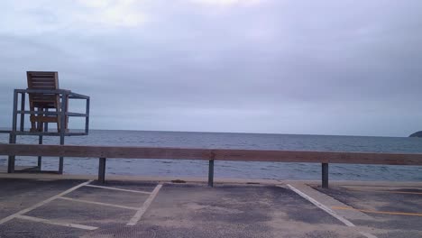 Empty-chair-seaside-waterfront-looking-at-the-ocean