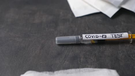 COVID-19-TEST-syringe-laying-on-a-table