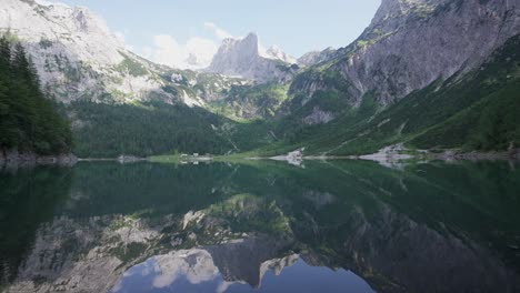 Symetrical-view-of-Gossausee,-beautiful-mountain-lake-in-the-Austrian-alps-with-reflections-of-the-mountains-in-the-water