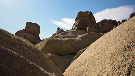 Rock-Formations-In-Joshua-Tree-National-Park-With-Bright-Blue-Sky-On-The-Background--wide-shot