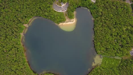 Bird's-eye-view-of-Joshua-Pond-surrounded-by-a-dense-forest-in-Massachusetts
