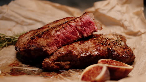 Juicy-caramelized-steak-cut-in-half-cooked-medium-rare,-rustic-presentation