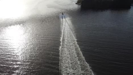 High-Drone-flight-behind-a-jetsky-traveling-over-the-water