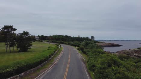 Causeway-pavement-road-seaside-of-rocky-beach-in-a-residential-area-at-Nahant,-a-two-way-road-in-an-isthmus