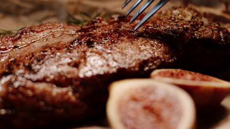 Cutting-delicious-steak-with-knife-and-fork,-checking-red-color-of-meat